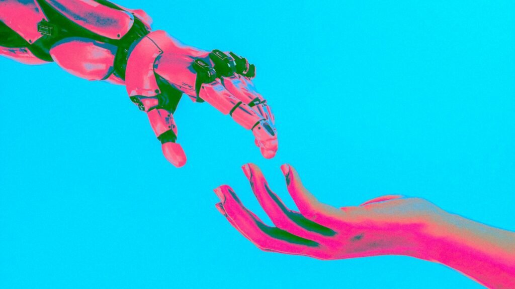 Main de robot et main humaine tendues l'une vers l'autre